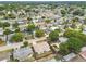 An aerial view of a residential neighborhood featuring single-story homes with mature trees and landscaping at 5642 Dove Dr, New Port Richey, FL 34652