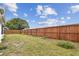 Large backyard with a wooden fence offers privacy and space for recreation and gardening at 5642 Dove Dr, New Port Richey, FL 34652