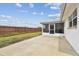 An open patio space offers relaxation and entertainment with a view of the fenced backyard at 5642 Dove Dr, New Port Richey, FL 34652