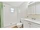 Bathroom with shower, sink, toilet, mirror, and green curtain at 5642 Dove Dr, New Port Richey, FL 34652