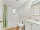 Bathroom with shower, sink, toilet, mirror, and green curtain at 5642 Dove Dr, New Port Richey, FL 34652