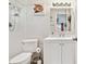 Bathroom with a white vanity, a toilet, and a shower head at 5642 Dove Dr, New Port Richey, FL 34652