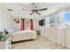 Cozy bedroom featuring a ceiling fan, a painting, and light colored wood flooring at 5642 Dove Dr, New Port Richey, FL 34652