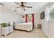 Bedroom featuring a ceiling fan, a flat-screen TV, and light colored wood flooring at 5642 Dove Dr, New Port Richey, FL 34652