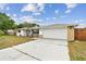 Charming single-story home with a manicured lawn, two-car garage, and welcoming front porch at 5642 Dove Dr, New Port Richey, FL 34652