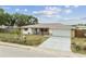Charming single-story home featuring well-maintained landscaping, including a palm tree and metal fence at 5642 Dove Dr, New Port Richey, FL 34652