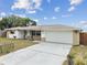 Charming single-story home features a two-car garage and a well-manicured front yard at 5642 Dove Dr, New Port Richey, FL 34652