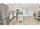 Bright kitchen features stainless steel appliances, white cabinetry, and a charming kitchen island at 5642 Dove Dr, New Port Richey, FL 34652