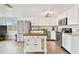 Bright kitchen features stainless steel appliances, white cabinetry, and a charming kitchen island at 5642 Dove Dr, New Port Richey, FL 34652