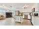 Bright kitchen features stainless steel appliances, white cabinetry, and a charming kitchen island at 5642 Dove Dr, New Port Richey, FL 34652