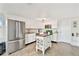 Bright kitchen features stainless steel appliances, white cabinetry, and a charming kitchen island at 5642 Dove Dr, New Port Richey, FL 34652