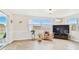 Open living area featuring sliding glass doors, large windows, and stylish furnishings at 5642 Dove Dr, New Port Richey, FL 34652