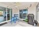 Covered patio with table, chairs, grill and string lights offers space for outdoor activities and entertaining at 5642 Dove Dr, New Port Richey, FL 34652