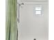 Shower with tiled walls, and floors with green curtain at 5642 Dove Dr, New Port Richey, FL 34652