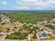 Aerial view of the home and surrounding neighborhood, nestled among lush greenery at 6197 Belkton Ave, Spring Hill, FL 34608