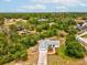 Aerial view of home featuring a grey roof and long concrete driveway at 6197 Belkton Ave, Spring Hill, FL 34608