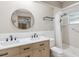 Bathroom with double vanity, shower, and stylish fixtures at 6197 Belkton Ave, Spring Hill, FL 34608