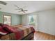Bedroom with wood floors, a ceiling fan, and natural light from the window at 6197 Belkton Ave, Spring Hill, FL 34608