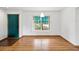 Bright entryway with hardwood floors and a view to the landscaped front yard at 6197 Belkton Ave, Spring Hill, FL 34608