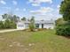Well-kept home featuring a green front door, clean driveway and inviting lawn at 6197 Belkton Ave, Spring Hill, FL 34608