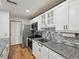 Updated kitchen featuring granite countertops, stainless steel appliances, and white cabinetry at 6197 Belkton Ave, Spring Hill, FL 34608