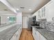 Modern kitchen featuring granite countertops, stainless steel appliances, and ample cabinet space at 6197 Belkton Ave, Spring Hill, FL 34608