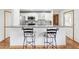 Modern kitchen featuring granite countertops and white cabinetry, with bar stool seating at 6197 Belkton Ave, Spring Hill, FL 34608
