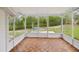 Screened lanai with wood-look flooring, offering a tranquil outdoor living space at 6197 Belkton Ave, Spring Hill, FL 34608