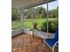 Screened lanai with a view of the backyard, perfect for relaxing outdoors at 6197 Belkton Ave, Spring Hill, FL 34608