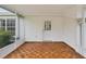 Screened lanai with wood-look flooring, creating a comfortable outdoor space at 6197 Belkton Ave, Spring Hill, FL 34608