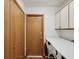 A laundry room with a washer and dryer, as well as upper cabinets for storage at 6197 Belkton Ave, Spring Hill, FL 34608