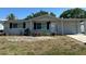 Charming single-story home featuring a well-manicured lawn and attached garage at 6406 Stone Rd, Port Richey, FL 34668