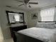 Relaxing bedroom featuring a comfortable bed, a large mirror, and light from the windows at 6603 Adams St, New Port Richey, FL 34652