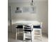 Cozy dining area featuring a white table set, nautical themed art and tiled floors at 6603 Adams St, New Port Richey, FL 34652
