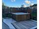 Backyard featuring a hot tub with wooden surround, creating a private and inviting outdoor space at 6603 Adams St, New Port Richey, FL 34652