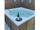 Relaxing hot tub with rustic wood paneling and space for drinks, ideal for entertaining or unwinding at 6603 Adams St, New Port Richey, FL 34652
