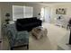 Cozy living room featuring tile floors, neutral paint, and comfortable seating perfect for relaxation at 6603 Adams St, New Port Richey, FL 34652