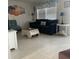 Bright living room with comfortable seating, stylish decor, and tile flooring at 6603 Adams St, New Port Richey, FL 34652