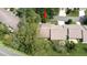 An aerial view reveals lush trees surrounding a cozy residential home at 6620 Brambleleaf Dr, Spring Hill, FL 34606
