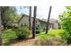 Backyard with lush green grass and mature trees at 6620 Brambleleaf Dr, Spring Hill, FL 34606