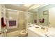Functional bathroom featuring a shower-tub combination with sliding glass doors and vanity sink at 6620 Brambleleaf Dr, Spring Hill, FL 34606