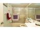 Bathroom showcasing a shower-tub combination with sliding glass doors and vanity, perfect for relaxation at 6620 Brambleleaf Dr, Spring Hill, FL 34606