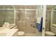 Clean bathroom with a toilet, sink, and shower with sliding glass doors at 6620 Brambleleaf Dr, Spring Hill, FL 34606