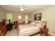 Bright bedroom with a queen bed, desk, and fresh decor creating a comfortable and inviting space at 6620 Brambleleaf Dr, Spring Hill, FL 34606
