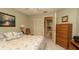 Well-lit bedroom with neutral decor, queen bed, and ensuite bathroom offers a relaxing retreat at 6620 Brambleleaf Dr, Spring Hill, FL 34606