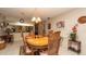 Inviting dining room features a wooden table, six chairs, and neutral decor for comfortable meals at 6620 Brambleleaf Dr, Spring Hill, FL 34606