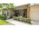 Inviting front porch with stone accents, a garden hedge, and ample seating area at 6620 Brambleleaf Dr, Spring Hill, FL 34606