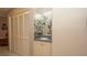 Hallway features a decorative bar, ample closet space, and tile flooring creating a neat and functional space at 6620 Brambleleaf Dr, Spring Hill, FL 34606