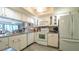 Bright kitchen featuring white cabinets, granite countertops, and modern appliances at 6620 Brambleleaf Dr, Spring Hill, FL 34606