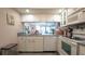 Kitchen featuring white cabinets, granite countertops, and modern appliances with an open floor plan at 6620 Brambleleaf Dr, Spring Hill, FL 34606